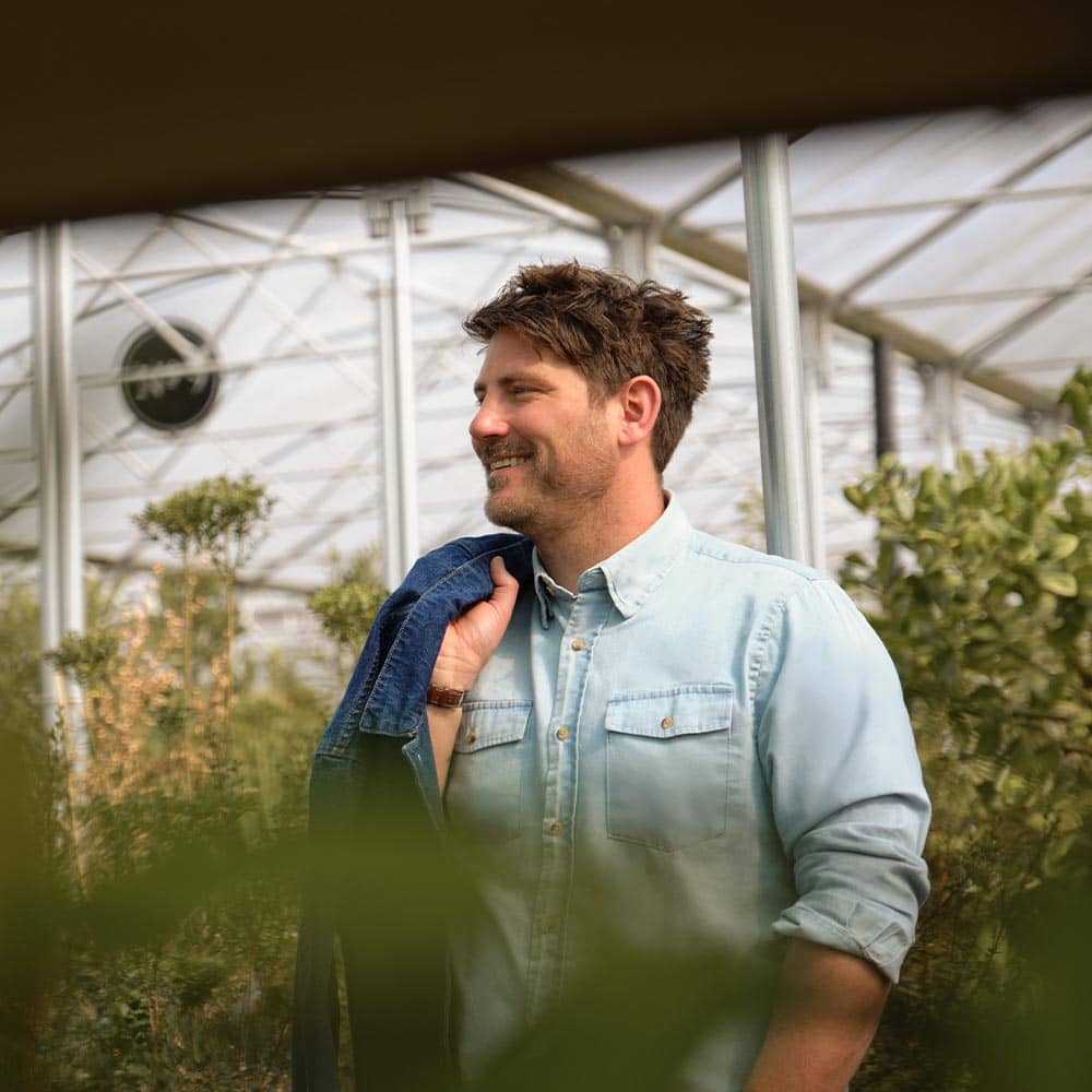 Guy smiling with Denim Chore Jacket over shoulder